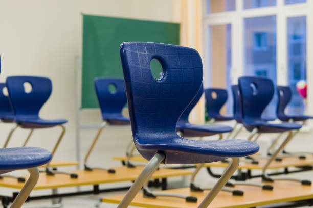 istock Blue chairs on the tables in the school office, 879166902