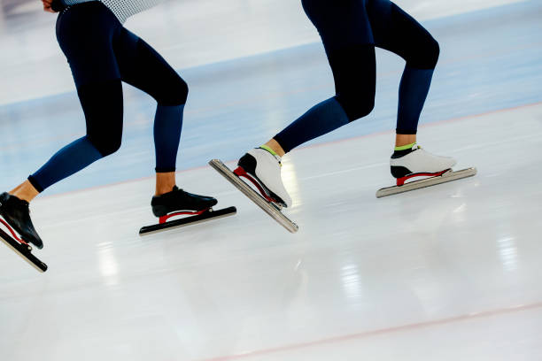 istock synchronous motion legs two athletes speed skaters on ice rink 879167040