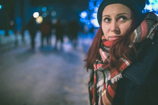 istock woman in night winter city 879172078