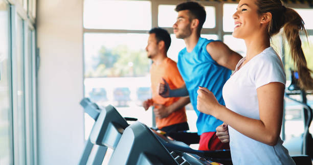 istock Group of friends exercising on treadmill machine 879177214