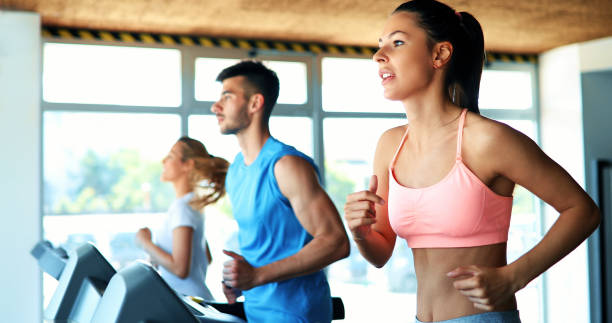 istock Young attractive woman doing cardio training in gym 879177504