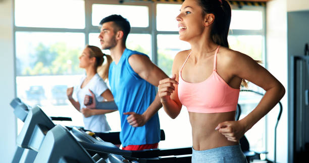 istock Group of friends exercising on treadmill machine 879177632