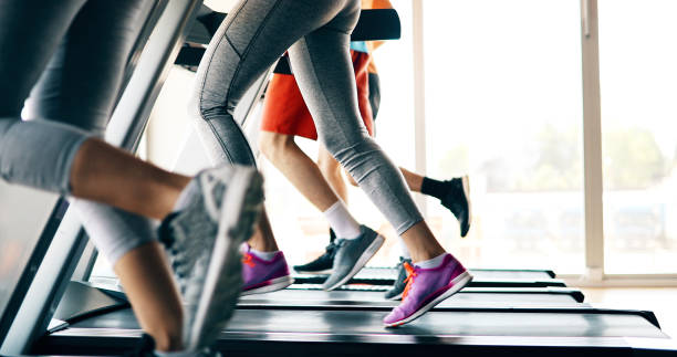 photo de gens courir sur tapis roulant en salle de gym - gymnase photos et images de collection