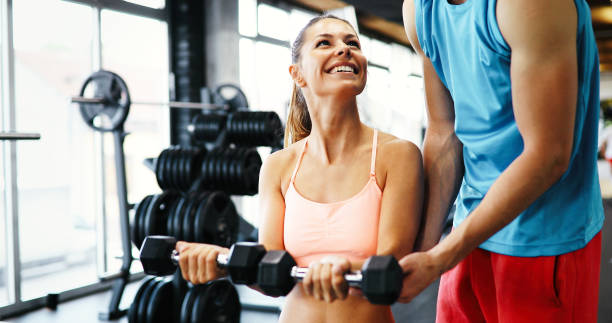 istock Beautiful woman exercising in gym 879181190