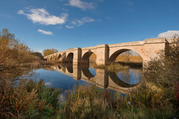 istock Fitero bridge, medieval bridge over Pisuerga river Palencia, Spain. 879187180