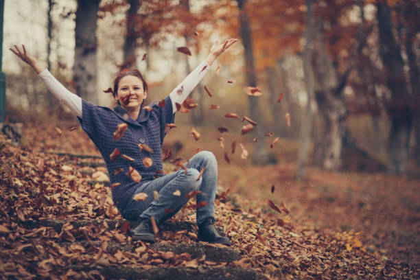 istock Happy autumn day-woman in forest 879196672