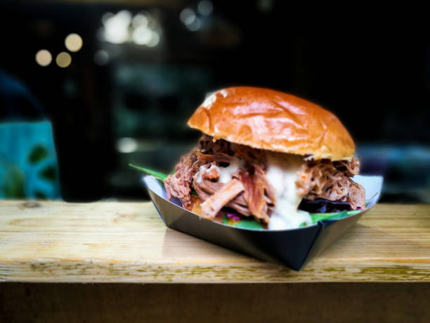 istock Freshly flame grilled pulled pork burger displayed at Borough Market, London 879207202