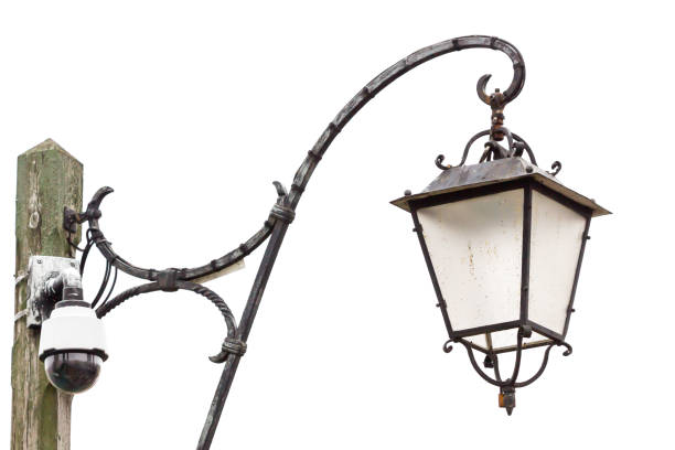istock Vintage street lampot with cctv camera, steel light post in downtown with security camera in old town in white background. 879213556