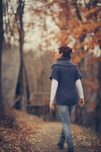 istock Happy autumn day-woman in forest 879222722