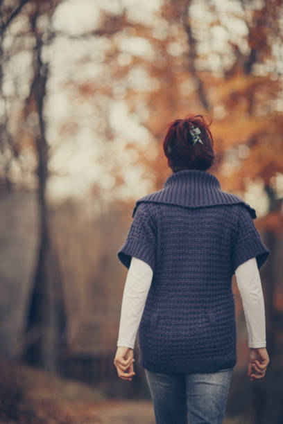 istock Happy autumn day-woman in forest 879226320