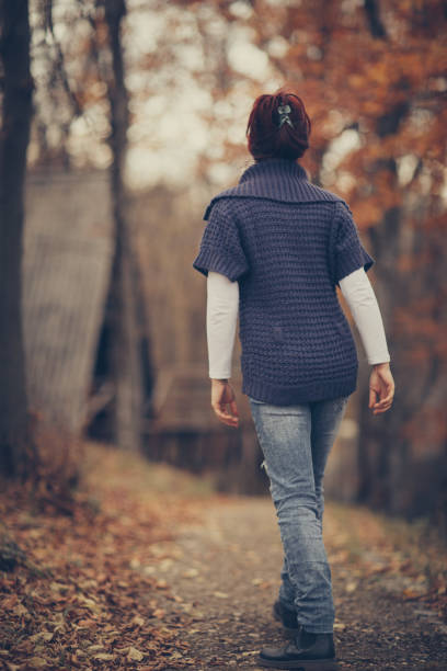 istock Happy autumn day-woman in forest 879230104