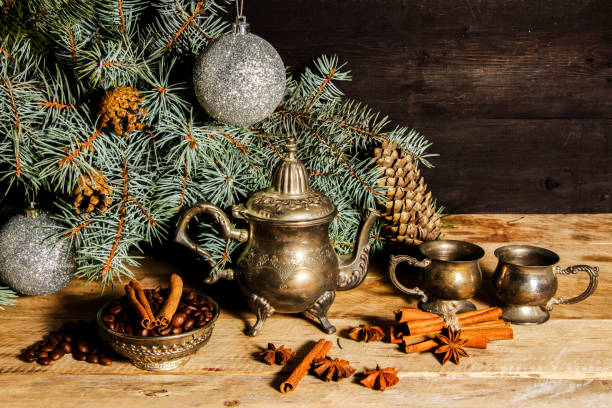 Christmas decoration background with coffee beans, silver antique oriental kettle, cinnamon, anise and spruce. Christmas decoration background with coffee beans, silver antique oriental kettle, cinnamon, anise and spruce. oriental spruce stock pictures, royalty-free photos & images