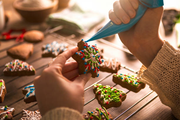 istock Adding the Icing on Baked Gingerbread Christmas star shape Cookie 879240156