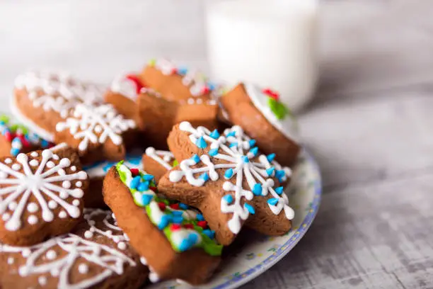 Photo of Milk and gingerbread cookies decorated with icing