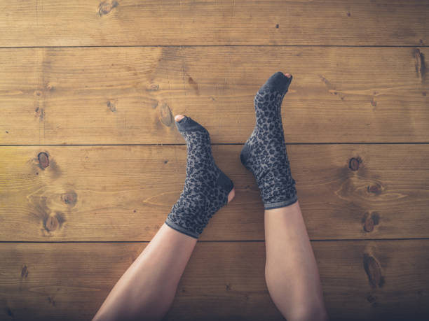 istock Over view of woman in worn socks 879243162