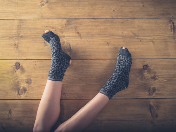 istock Over view of woman in worn socks 879243336