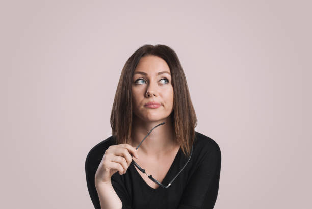 istock Young women with glasses thinking about something 879244282