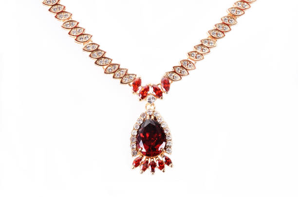 istock gold necklace with red crystals on a white background. 879244302