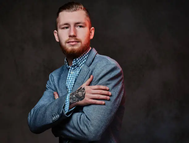 Photo of A man dressed in a suit over grey background.