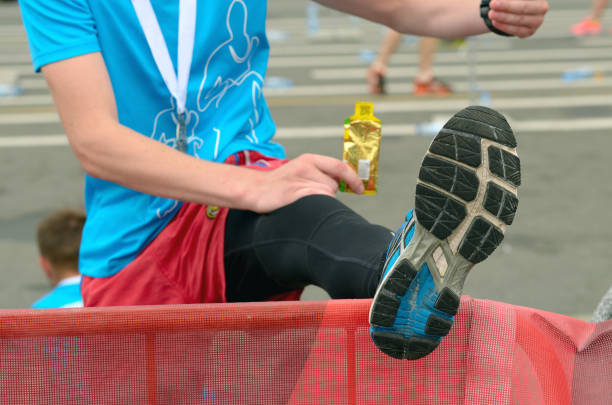 An athlete warms up his feet. An athlete warms up his feet.She's resting after the marathon. warms stock pictures, royalty-free photos & images