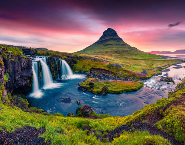 istock Summer sunset on famous Kirkjufellsfoss Waterfall and Kirkjufell mountain. 879254436