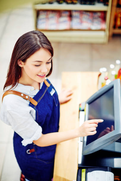 istock Deli owner looking away while using cash register in store 879254756