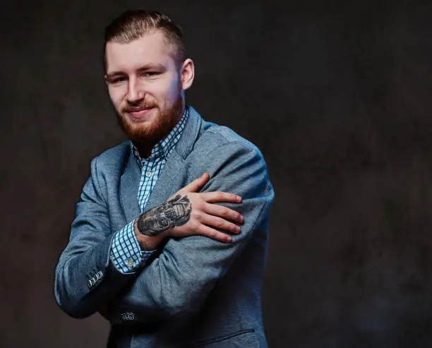 Photo of A man dressed in a suit over grey background.