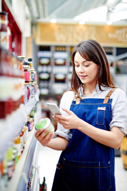 Beautiful deli owner scanning label on food container