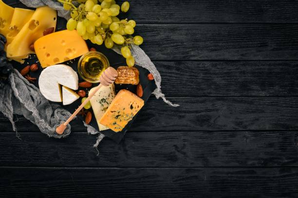 istock Grapes, red wine, cheeses, honey and nuts on a wooden background. Top view. 879261274