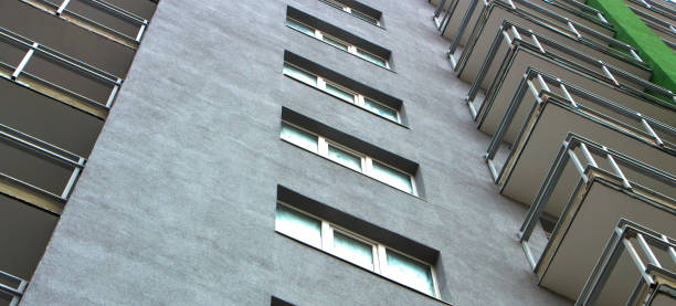 istock The facade of a typical block multi-storey residential building. Front view close up 879261486