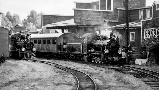 Steam trains by an old railway station ,antique, black and white processed