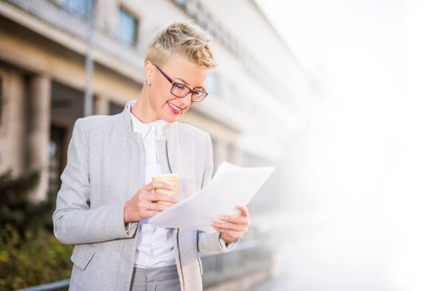 istock Happy businesswoman checking her paperwork. 879267750
