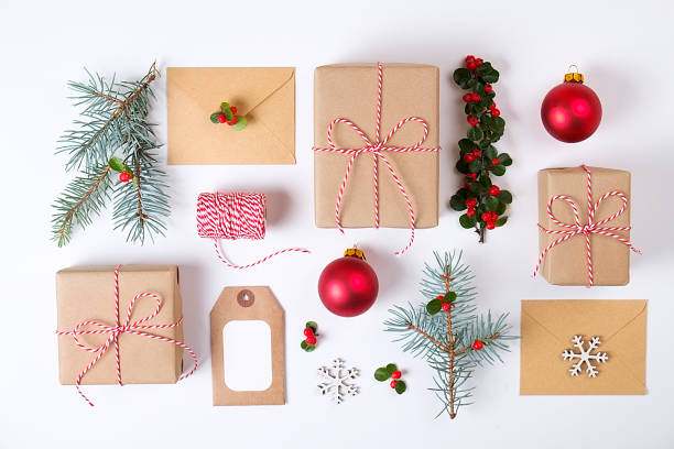 istock Christmas frame composition. Christmas gift,pine branch, red balls, envelope, white wood snowflakes, ribbon and red berries. Top view, flat lay, copy space 879273074