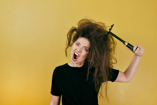istock annoyed girl combs her hair 879273104