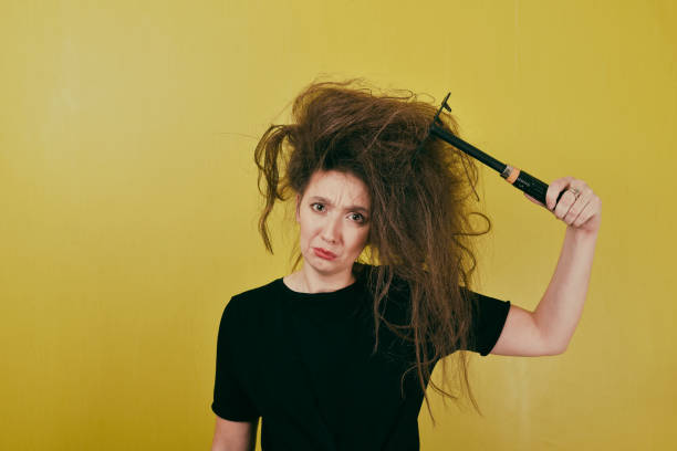 istock annoyed girl combs her hair 879273286