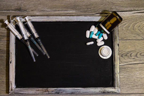 istock Medicine concept. Blackboard with ADHD , stethoscope ,pills and syringe 879278966