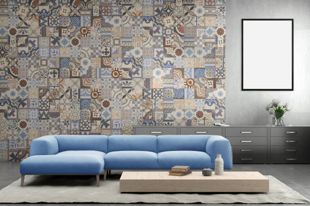 istock Blank picture frame on gray wall with sofa in front of it 879279980