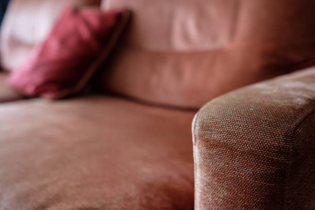 istock Blurred red and brown armrest of a sofa 879280428