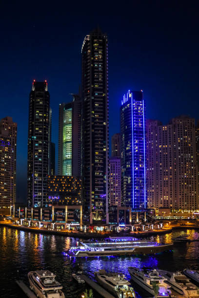 Night view of Dubai Marina Skyscrapers, Skyline with Marina Lake, United Arab Emirates Night view of Dubai Marina Skyscrapers, Skyline with Marina Lake, United Arab Emirates dubai marina panorama stock pictures, royalty-free photos & images