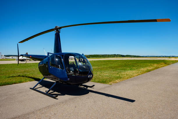 istock Blue helicopter at a airport with green meadow 879284258