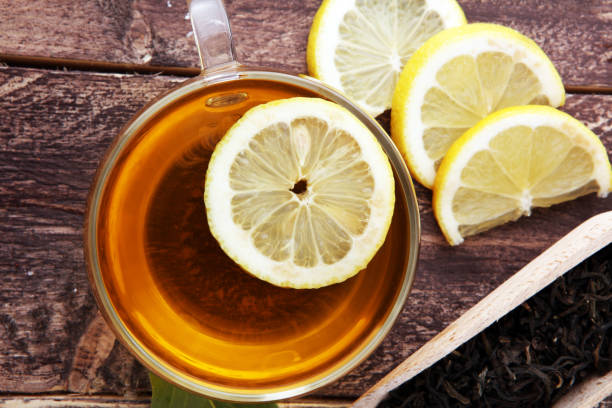 istock Hot tea in a transparent cup. Tea with lemon fruits. Warming drink. 879286630