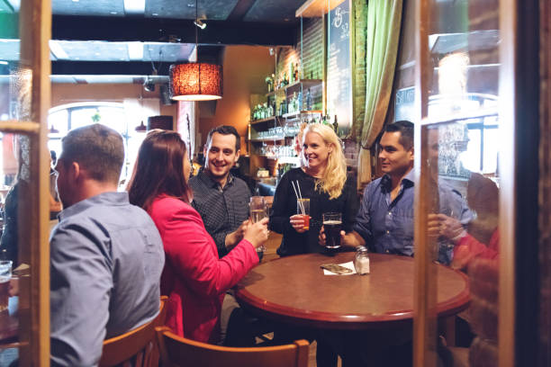 istock Coworkers hanging out in a bar, happy hour time 879286906