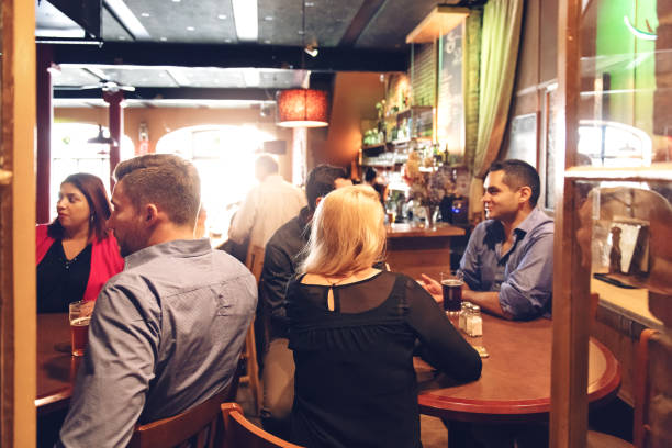 istock Coworkers hanging out in a bar, happy hour time 879286912