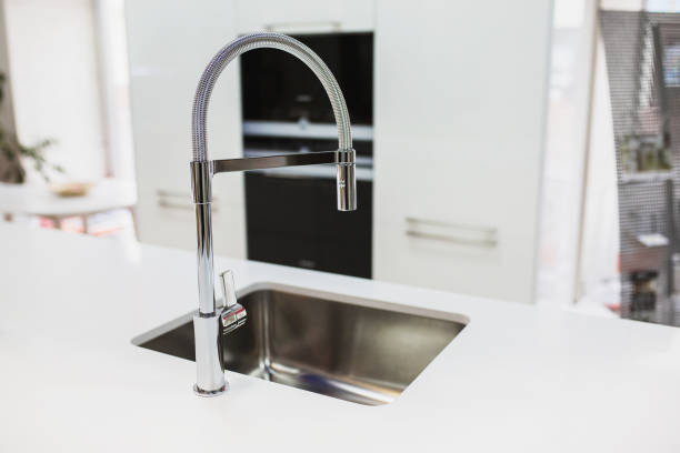 istock Metal crane with a stylish sink in the new kitchen. 879289440