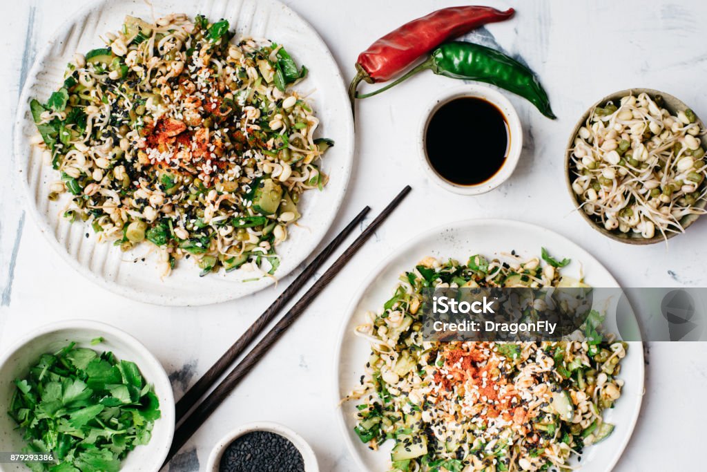 Healthy mung bean sprouts salad Healthy mung bean sprouts salad with black sesame seeds, cucumbers, spring onion and cilantro. Asian food, healthy eating concept Lentil Stock Photo