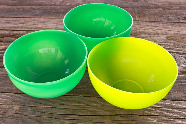 istock Plastic bowls on old wooden table background 879293732