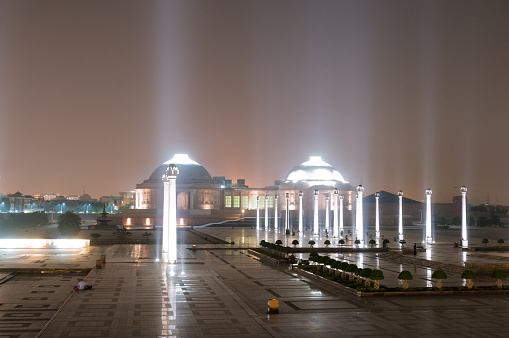 Ambedkar park at night showing the pillars  in the background. The beautiful lights ar evisible on this foggy night