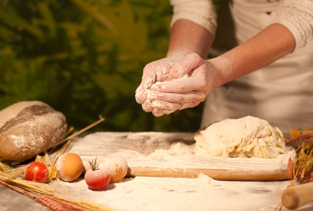 istock woman hands kneading dough 879299050