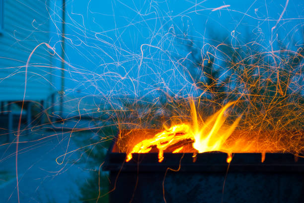 istock orange fire sparks metallic brazier on blue sky background house on the seashore 879302116
