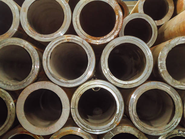 istock Large stack of thick-walled steel pipes for building structures. Industrial warehouse. 879302308